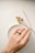 Close-up of a handcrafted wooden ring with visible natural grain and smooth finish.