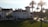 A well-maintained luxury vacation home exterior with elegant landscaping under soft sunlight.