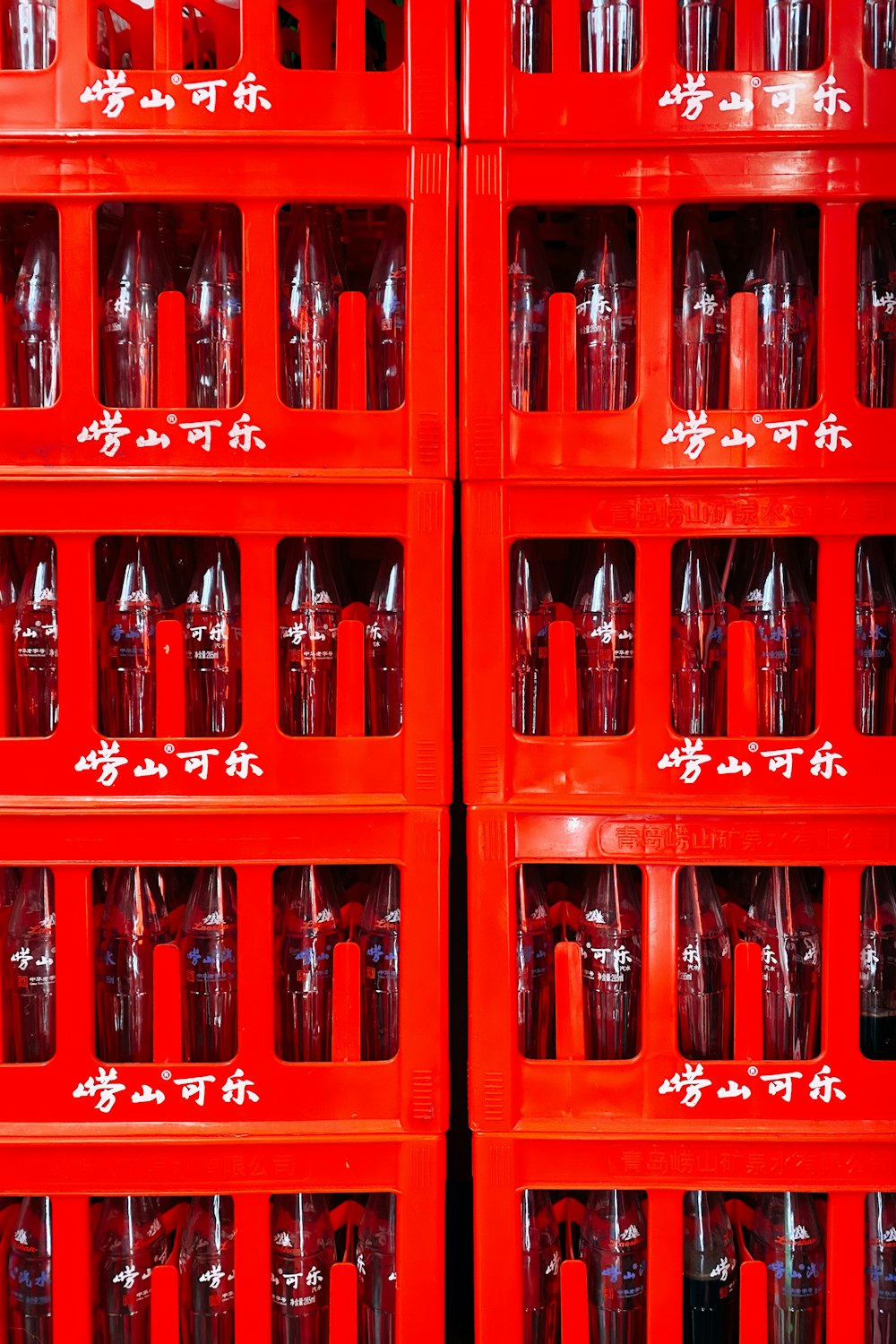coca cola bottles on red wooden shelf