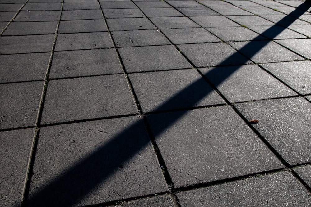 shadow of person on gray concrete pavement