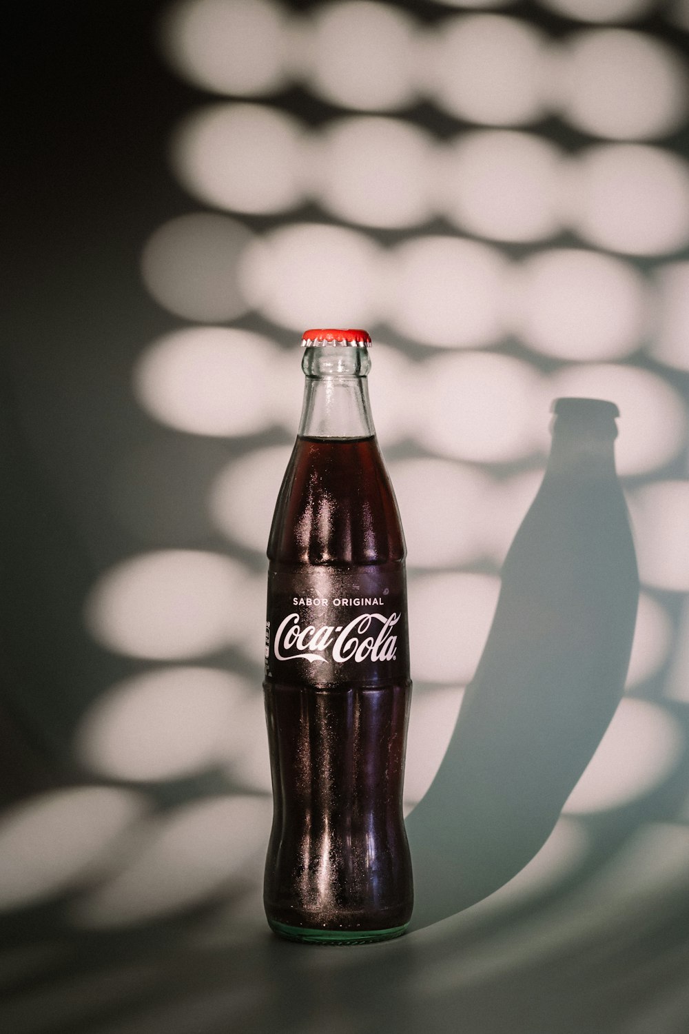 coca cola zero bottle on white table