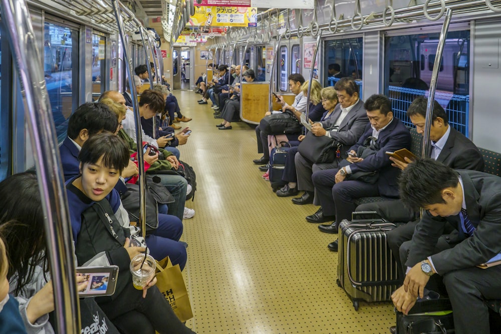 people sitting on black chair inside train