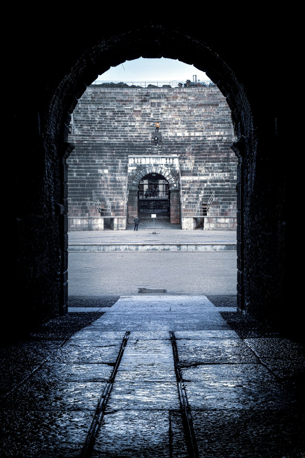 gray concrete hallway with arch shaped tunnel