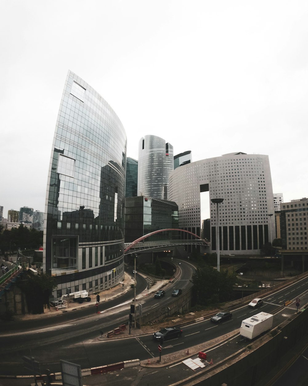 cars on road near high rise buildings during daytime