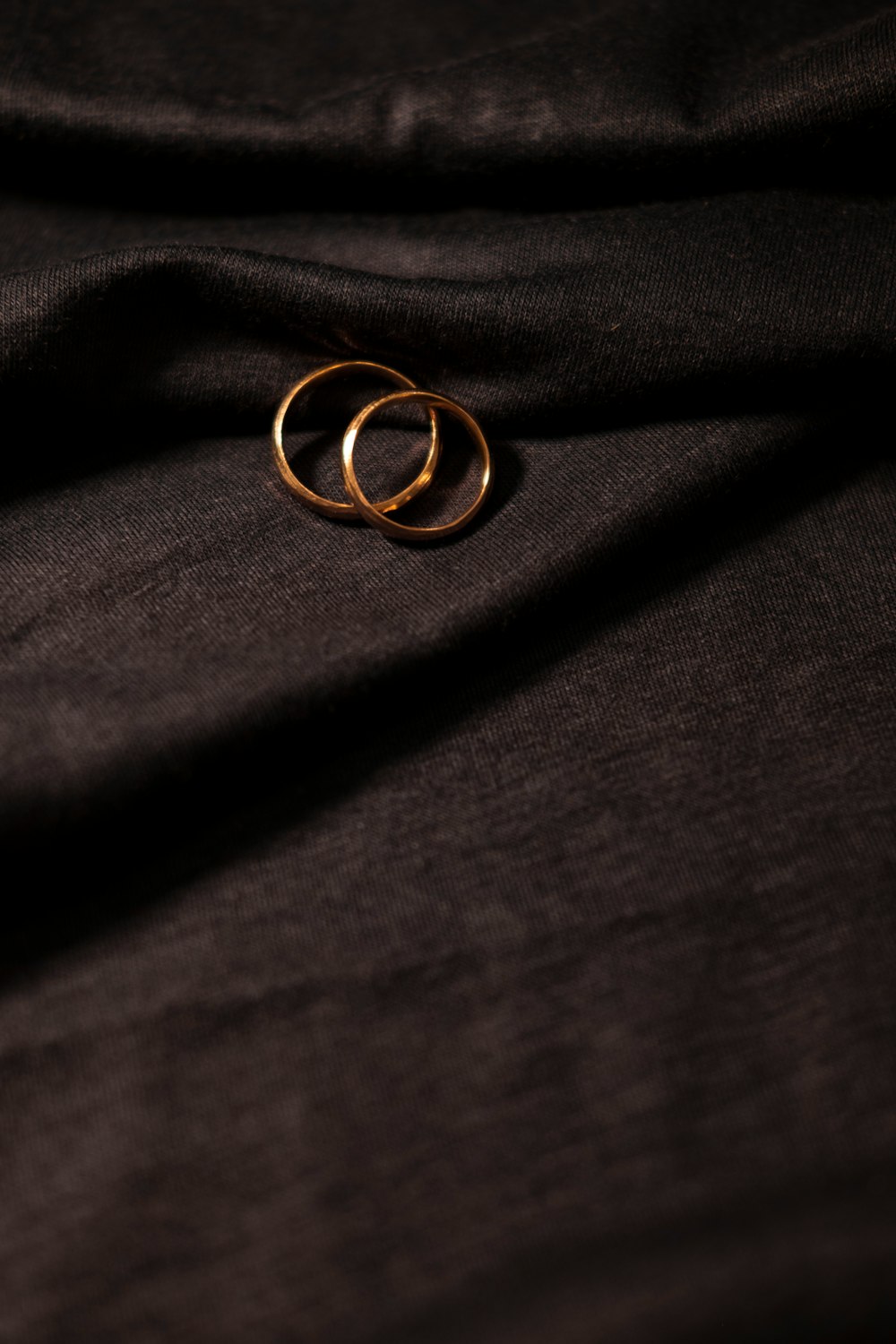 gold ring on black textile