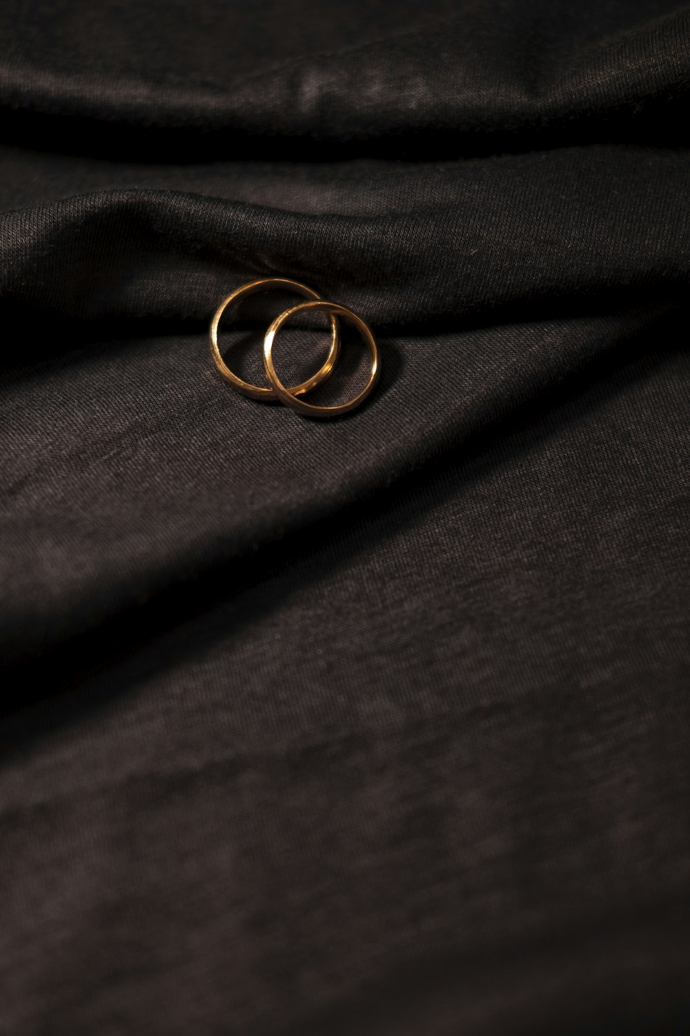 gold ring on black textile