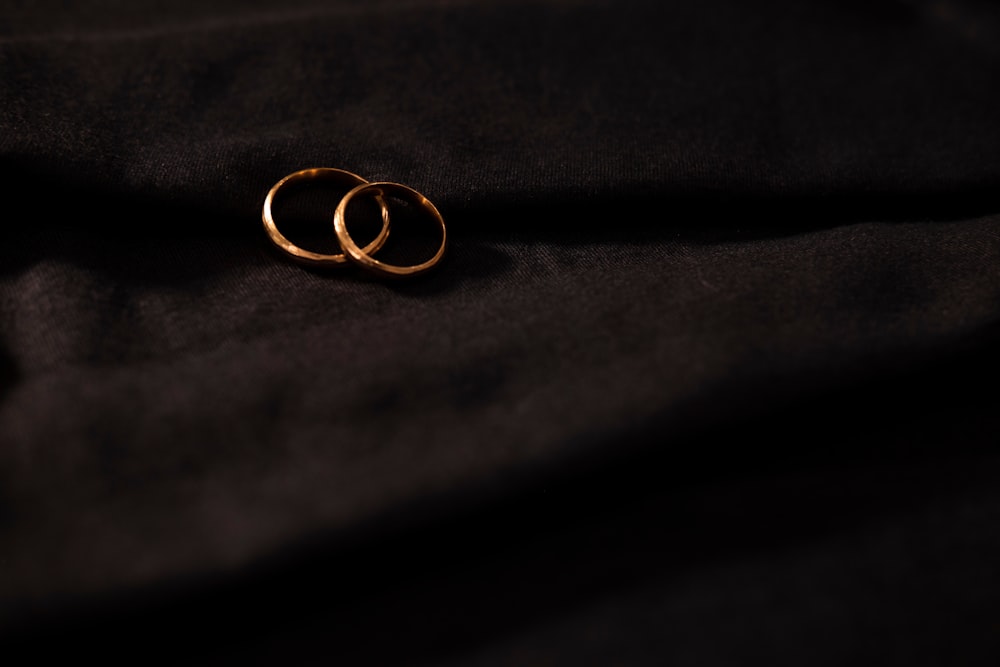 gold wedding band on black textile