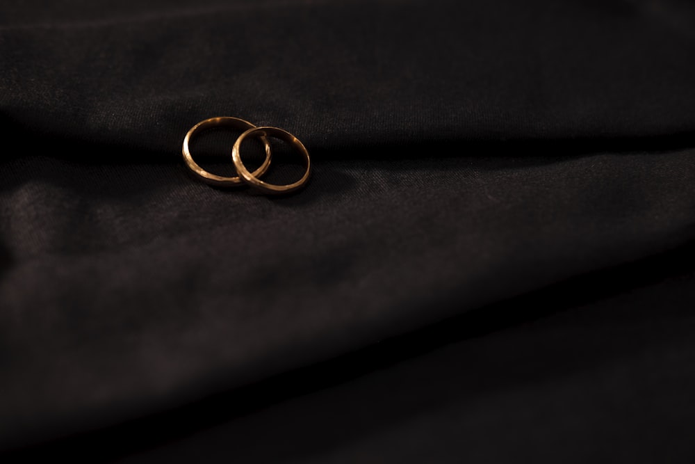 gold wedding band on black textile