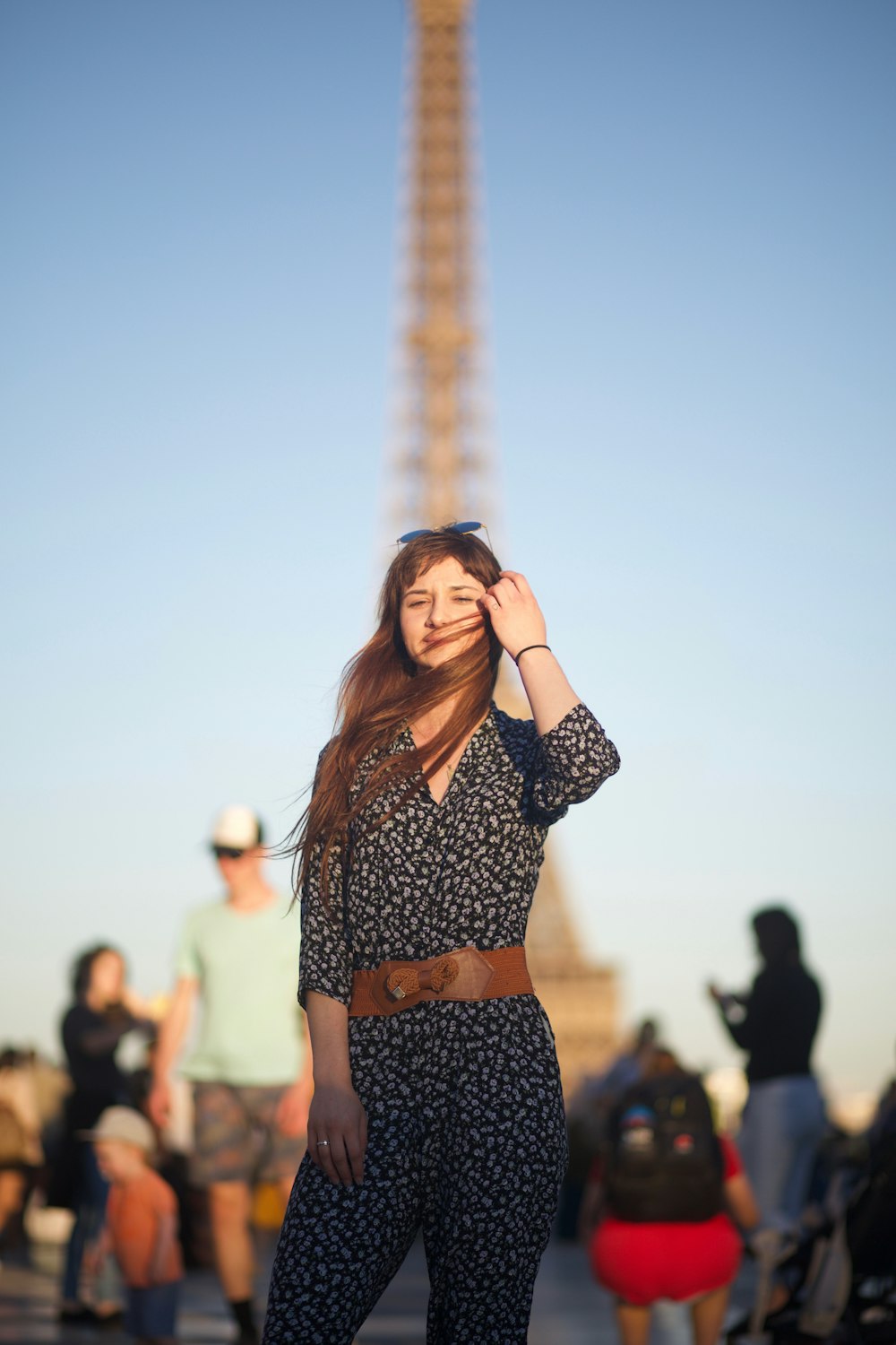 Une femme debout devant la Tour Eiffel