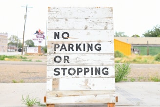 white and black wooden signage