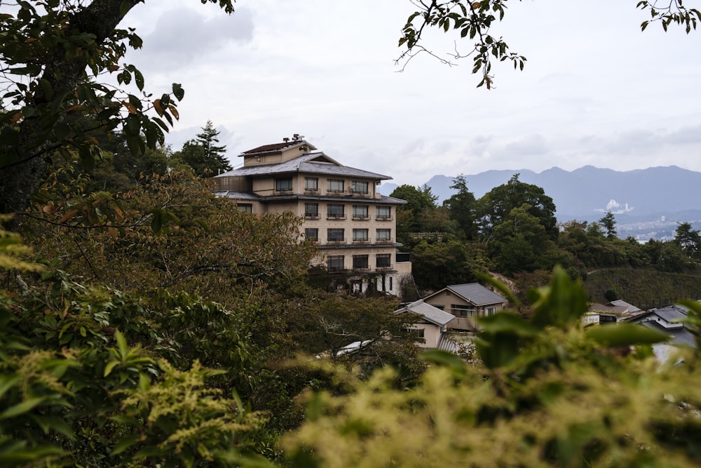 brown concrete building surrounded by green trees during daytime