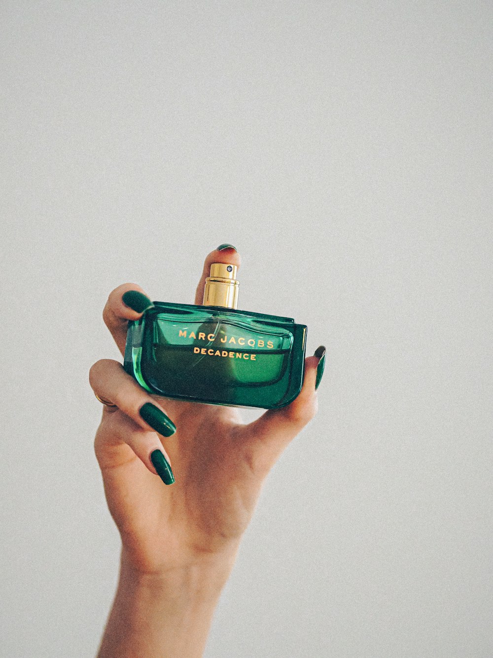 green and gold perfume bottle