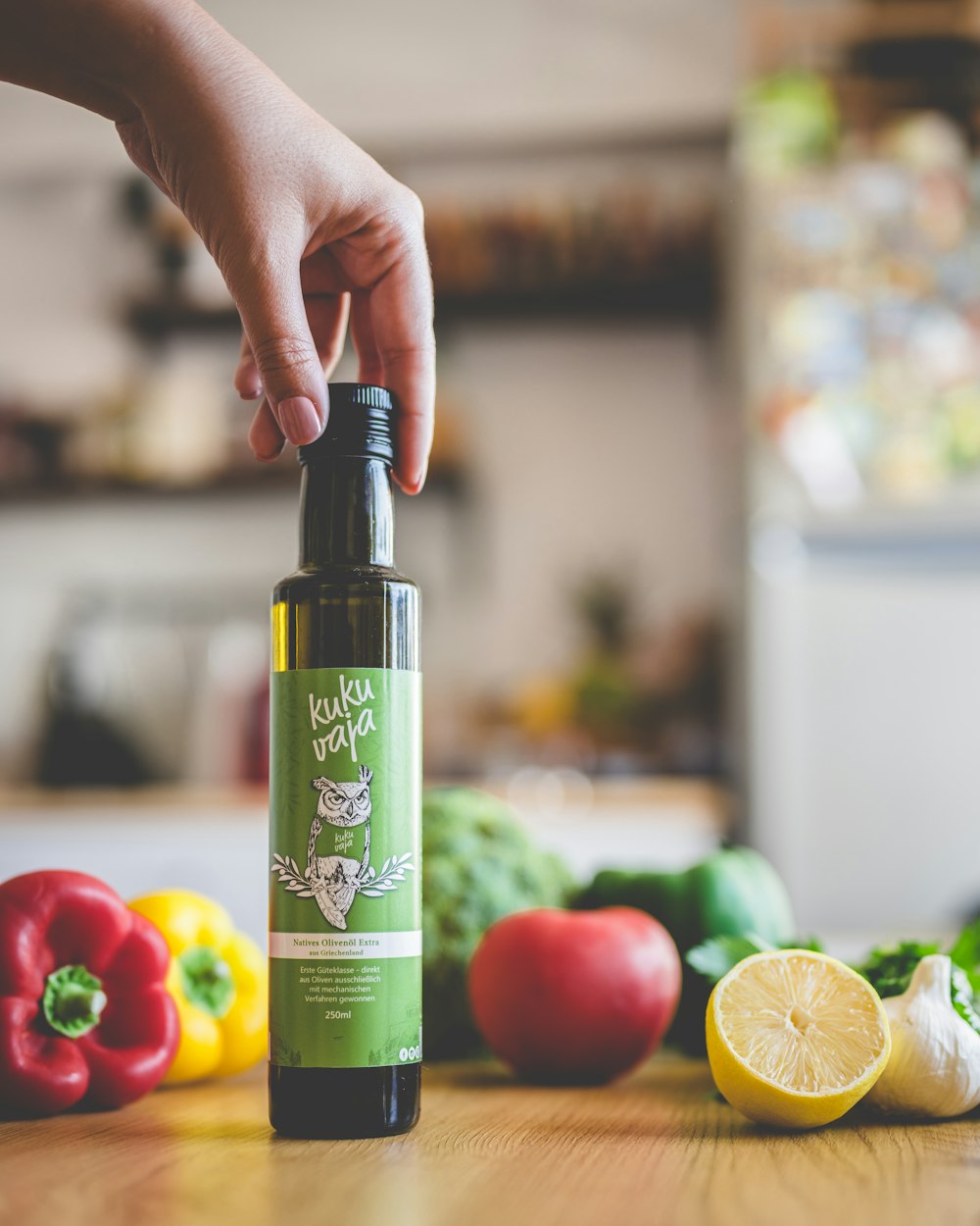 person holding green and white labeled bottle