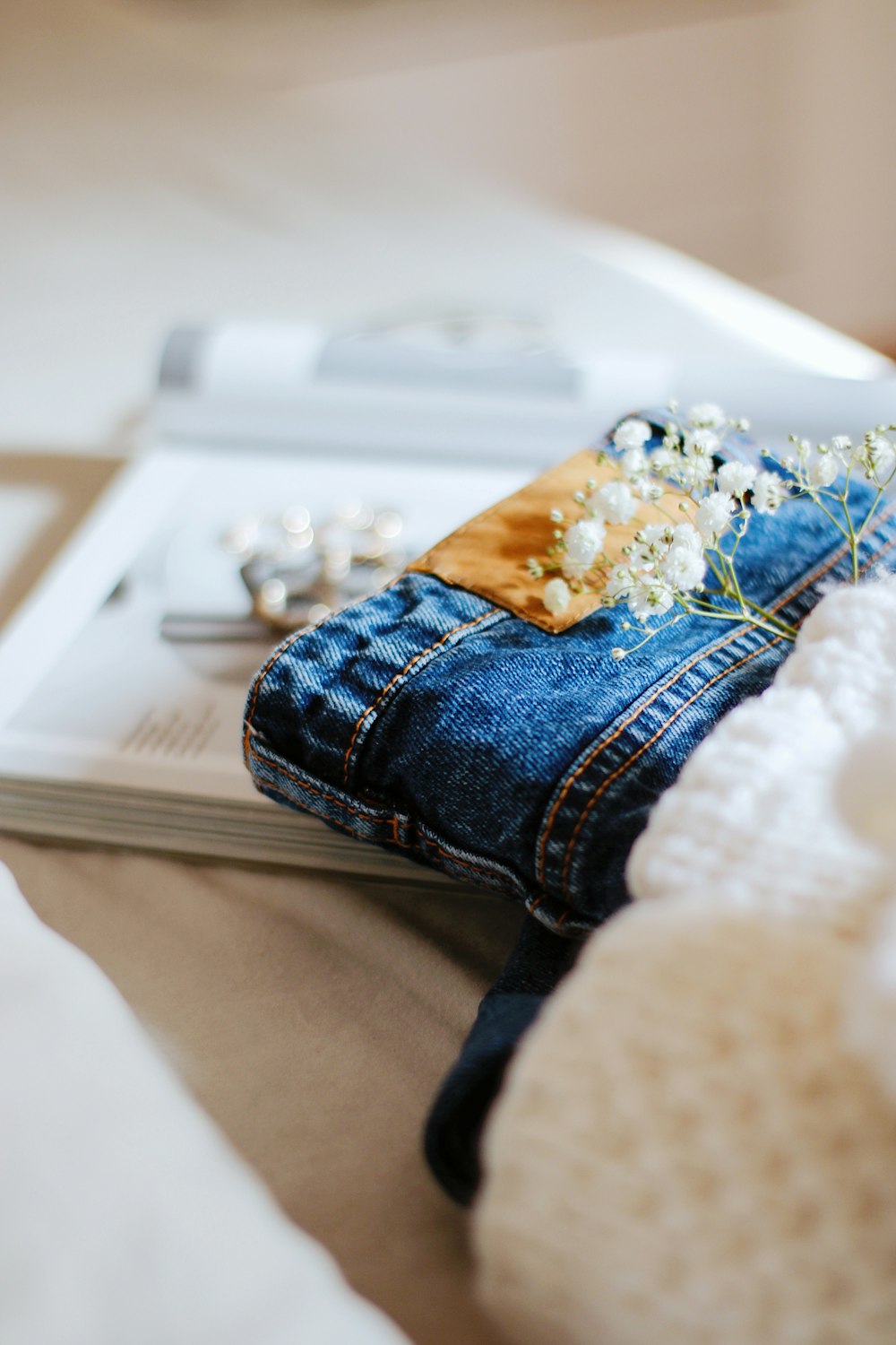 blue denim jeans on white table