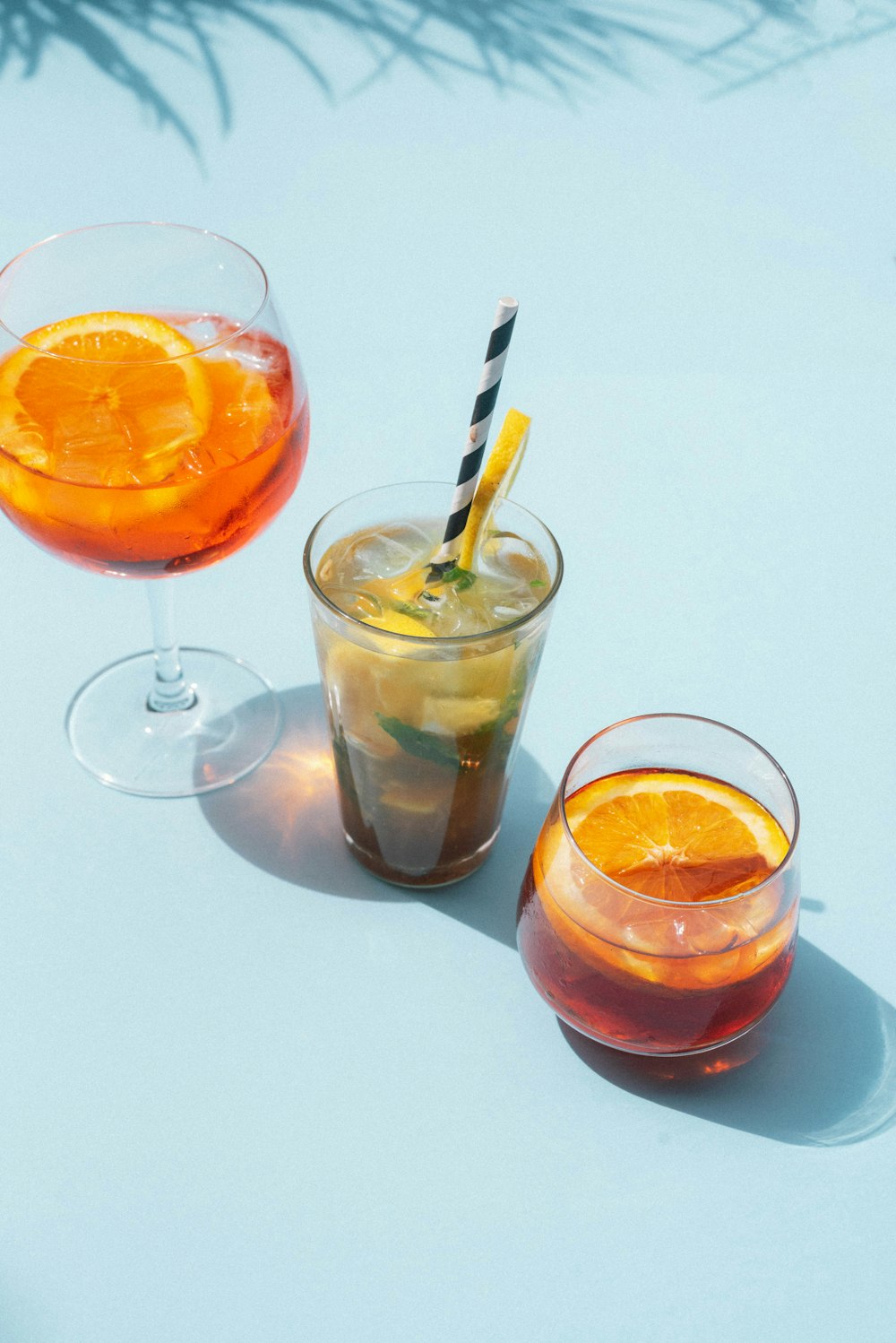 two clear drinking glasses with orange liquid