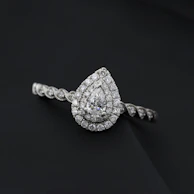 A modern engagement ring featuring a unique twisted band and a radiant-cut diamond.