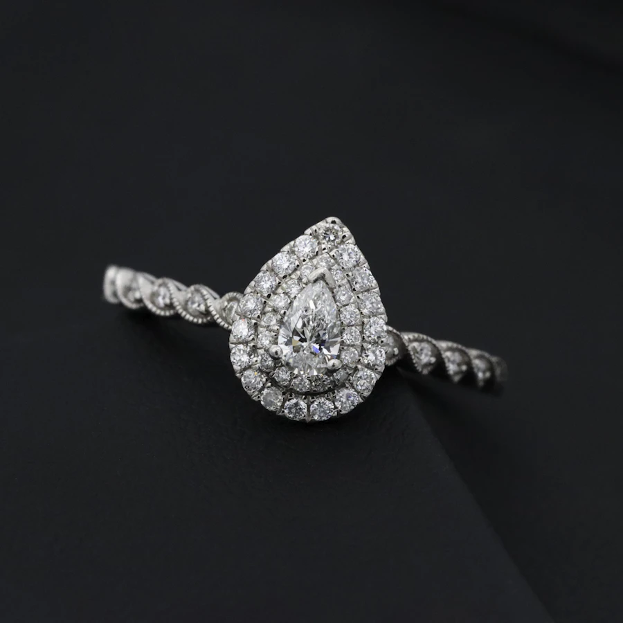 Pear diamond engagement ring with delicate diamond band
