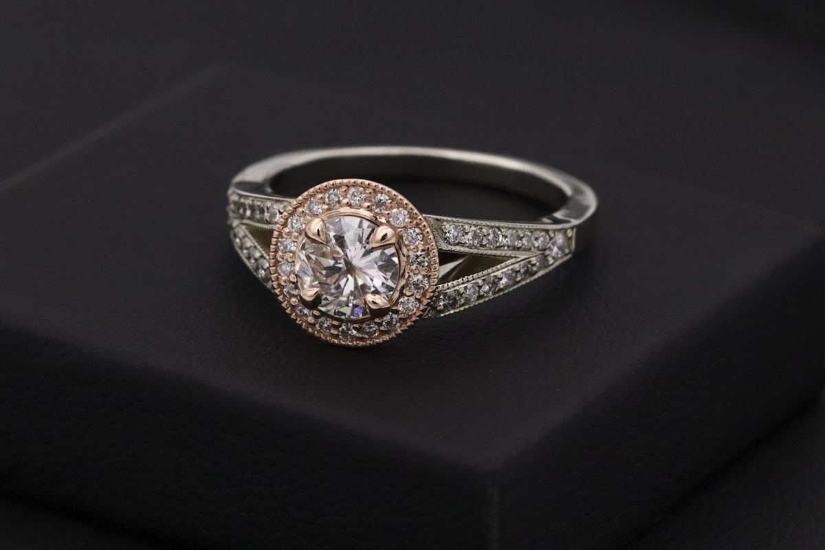 A solitaire ring with a deep blue gemstone on a polished band, styled against a soft neutral backdrop.