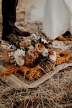 brown and white flowers on brown dried leaves