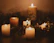 A serene spa room softly lit with candles and gentle greenery, inviting relaxation.