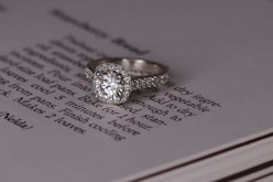 silver diamond ring on white book page