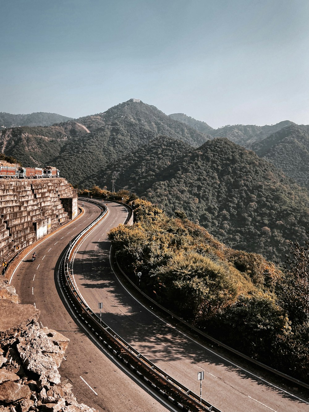 brown concrete building near mountain during daytime