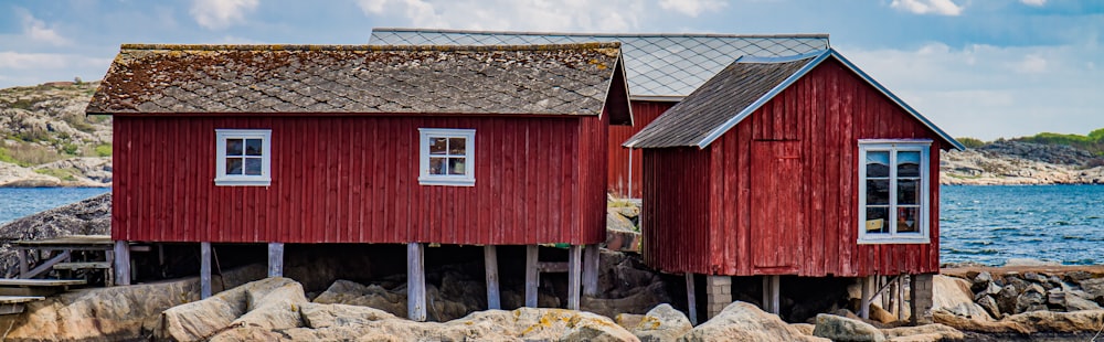 red and brown wooden house under white clouds during daytime