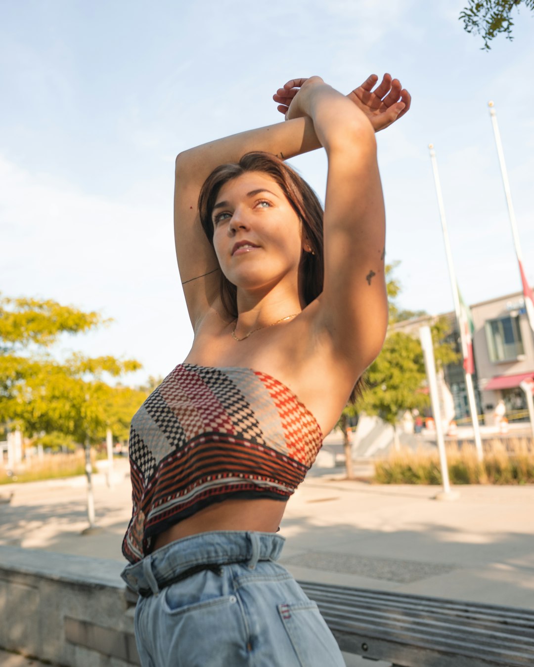 woman in blue denim shorts raising her right hand