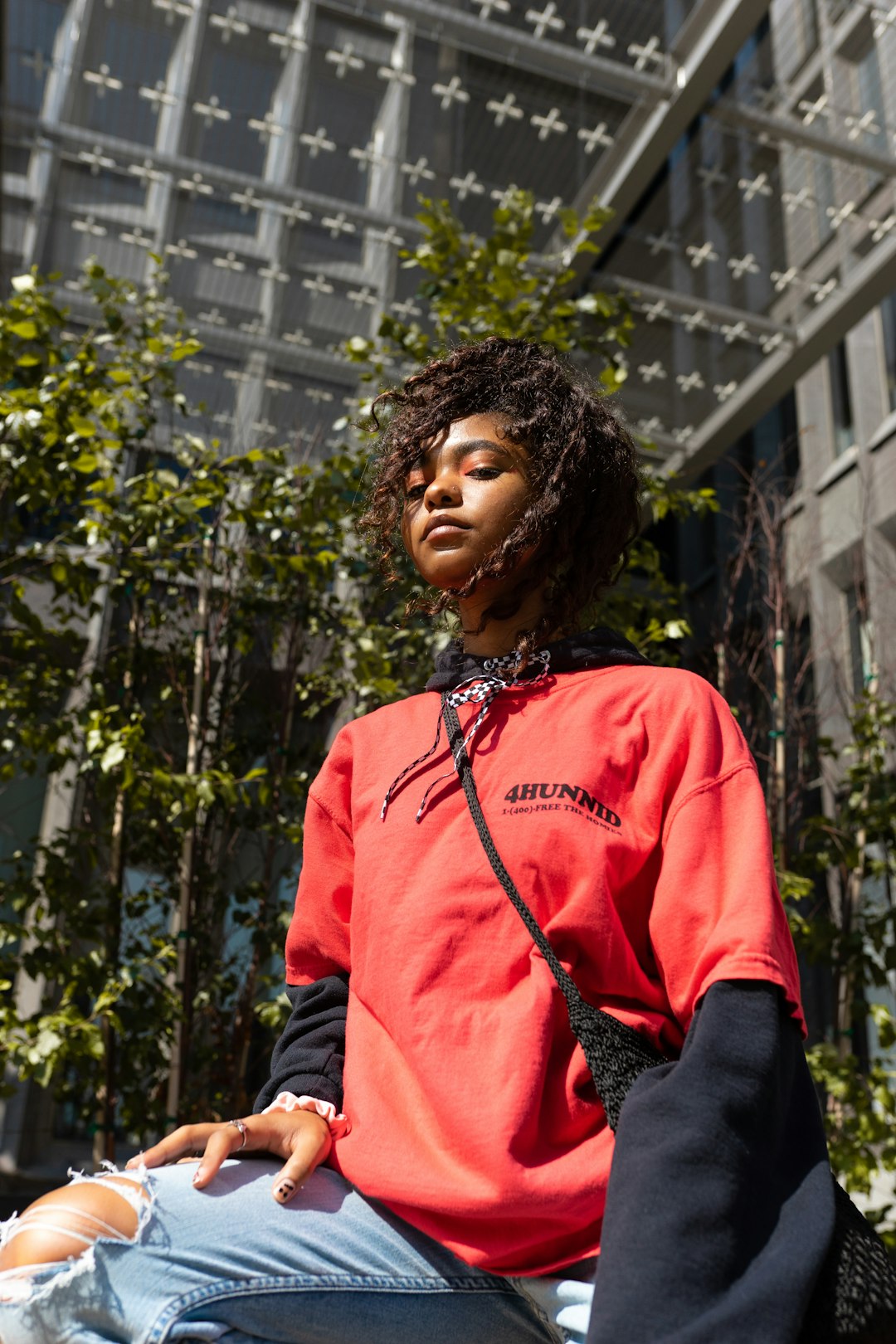 woman in red long sleeve shirt standing near green plants during daytime