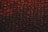 A close-up view of a sheet of bubble wrap with a dark, dramatic lighting. Each bubble is illuminated with an intense red and black contrast, highlighting the texture and translucency of the material.