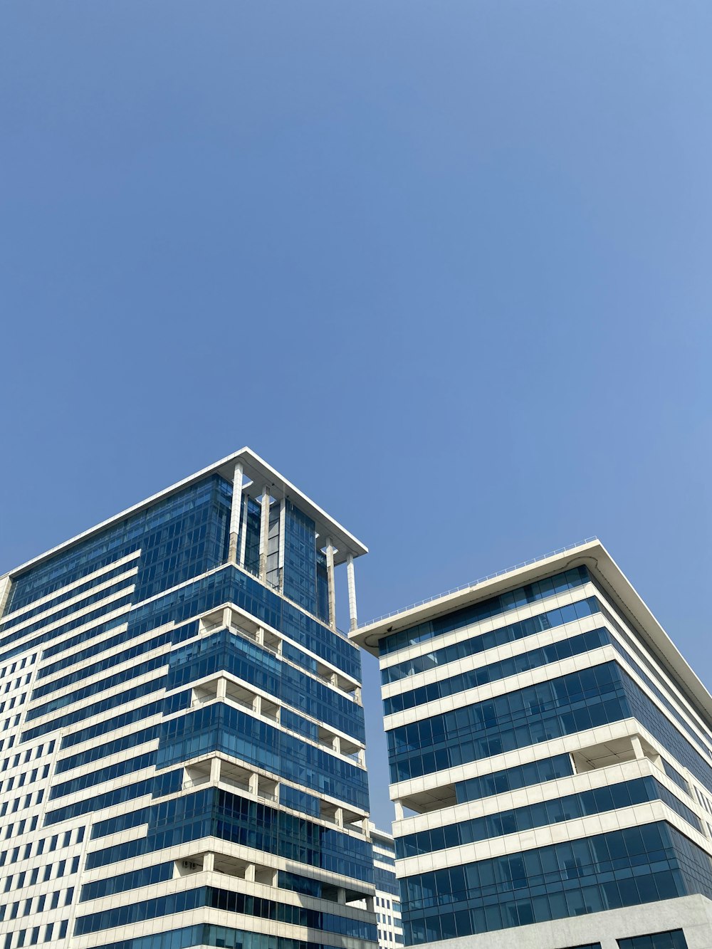 white and blue concrete building under blue sky during daytime