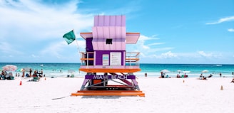 brown wooden lifeguard chair on beach during daytime