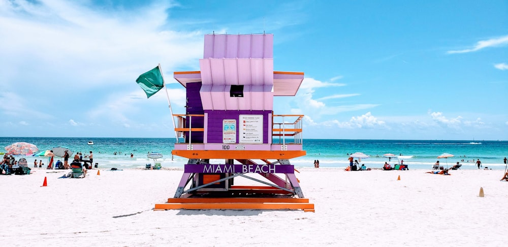 brown wooden lifeguard chair on beach during daytime