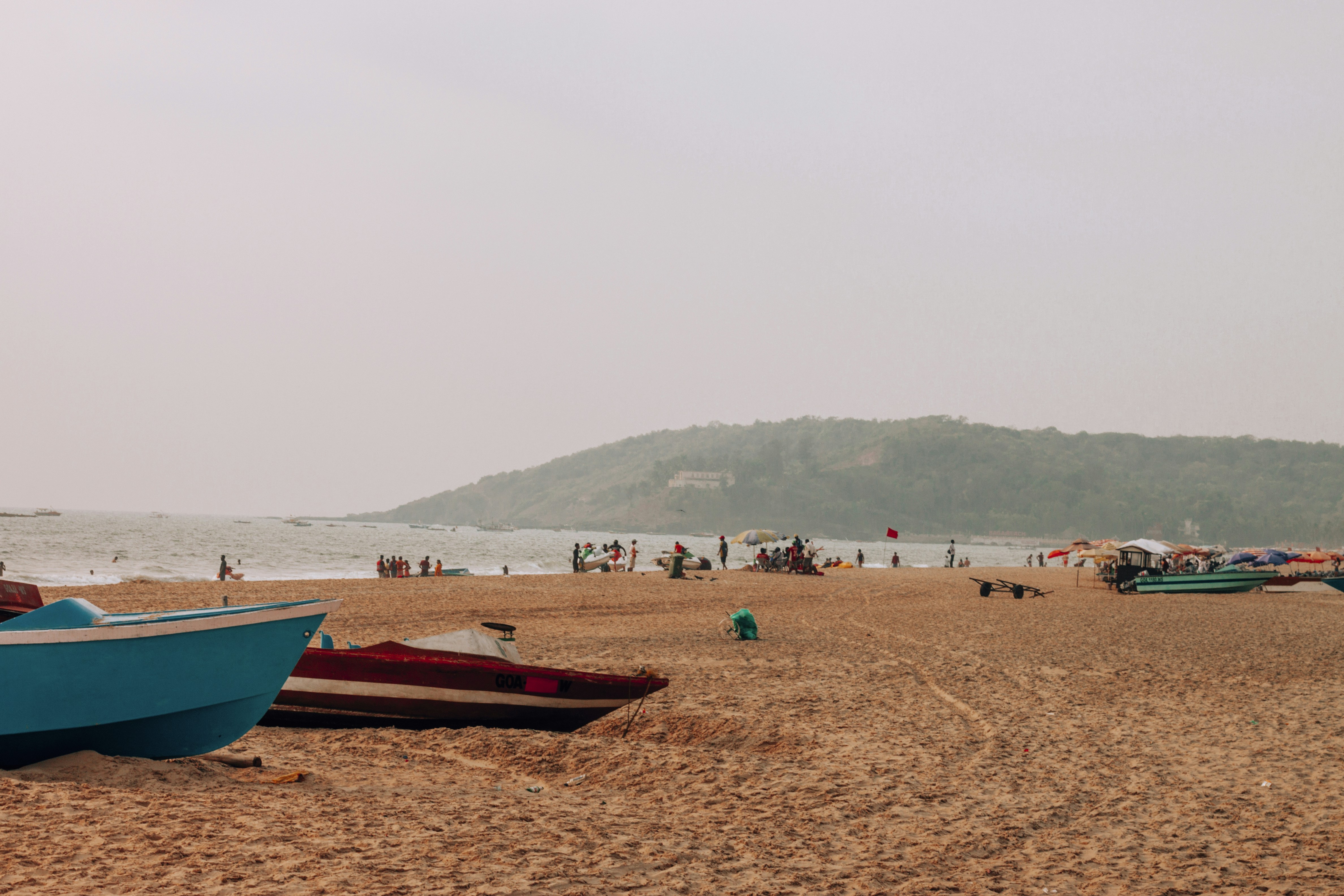 People spending time on a beach in Goa during the day