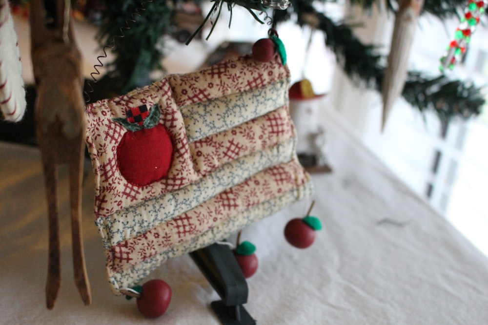 brown and red throw pillow on brown wooden chair