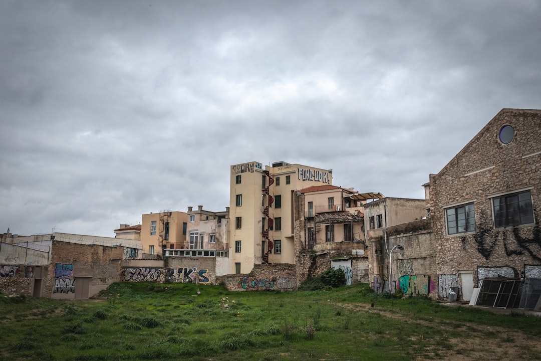 brown concrete building under white clouds during daytime