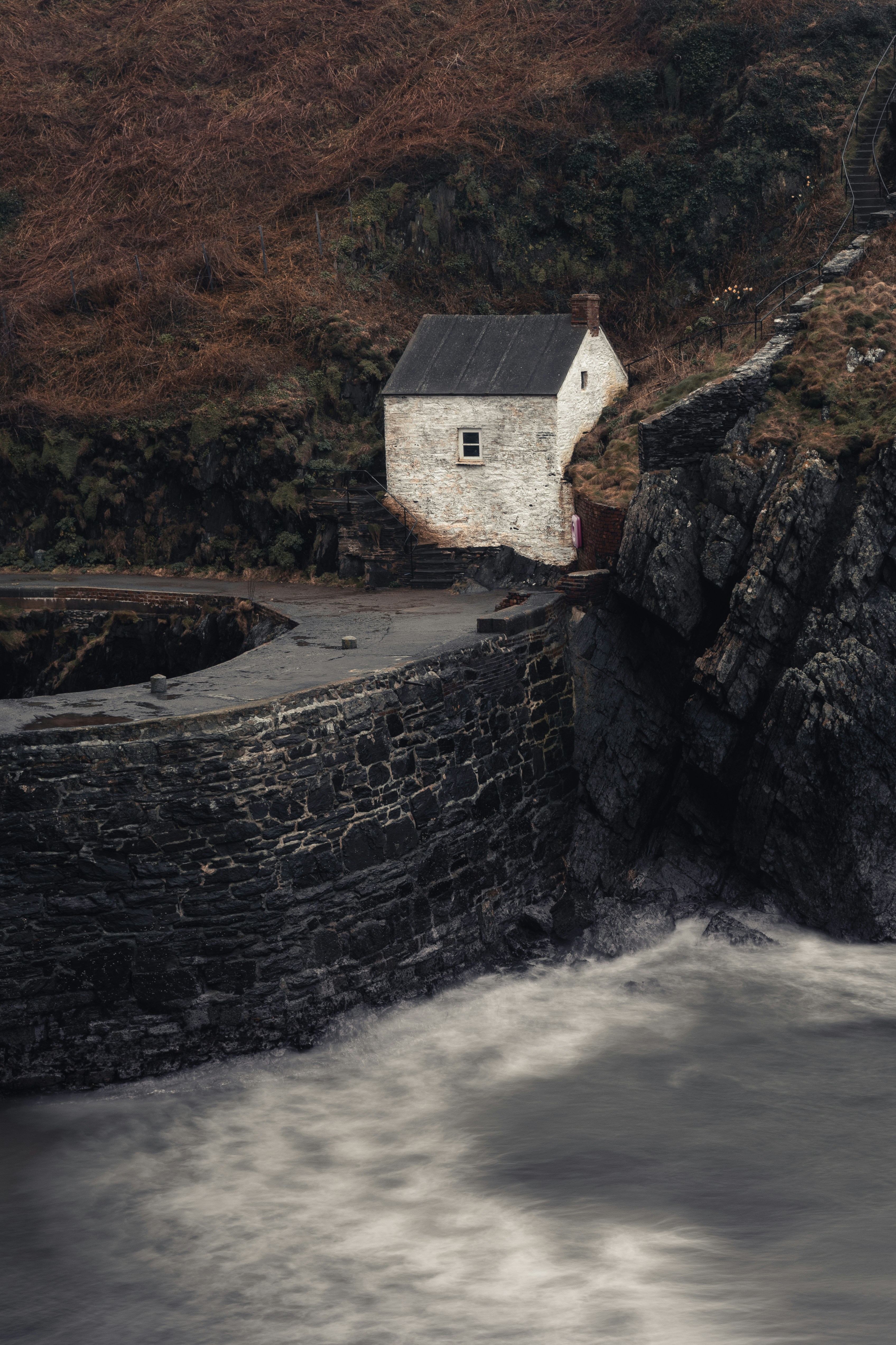 white-and-brown-house-beside-river