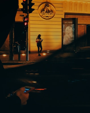 Person walking safely at night with the Bound Defense app active on their phone.