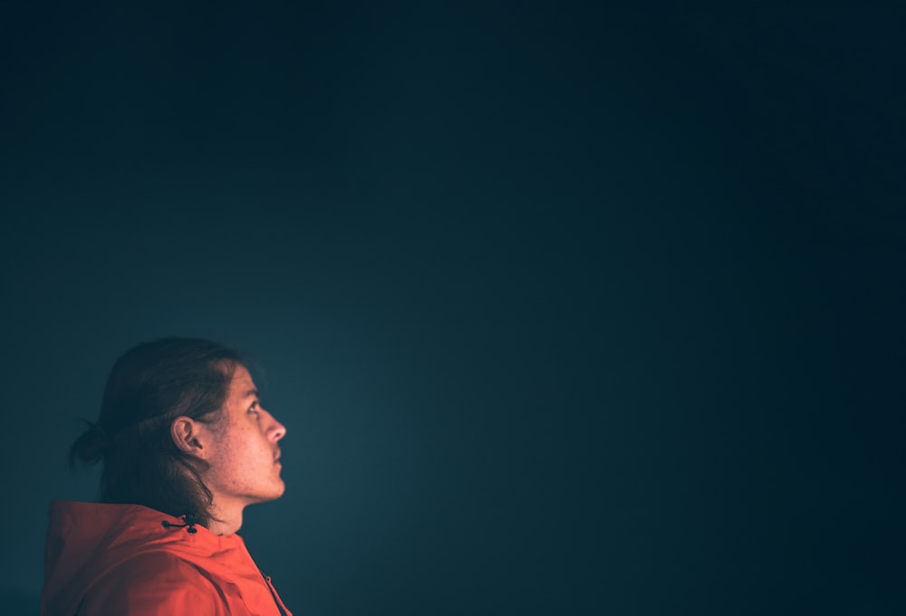 man in red hoodie looking up