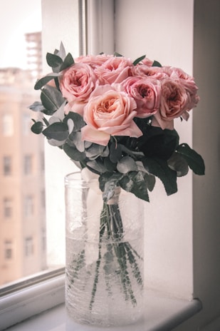 pink roses in clear glass vase
