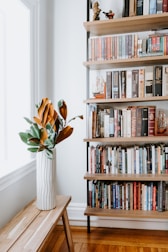 books on white wooden shelf
