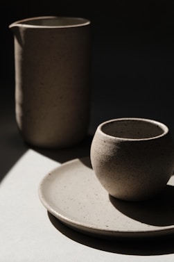 brown ceramic cup on white ceramic saucer