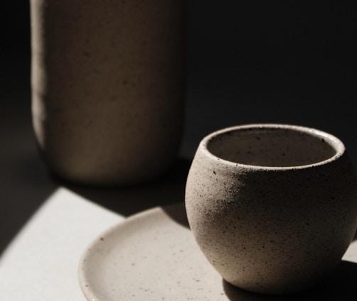 brown ceramic cup on white ceramic saucer
