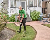 Professional landscaping equipment fitted with diamondmisina trimmer line in action outdoors.