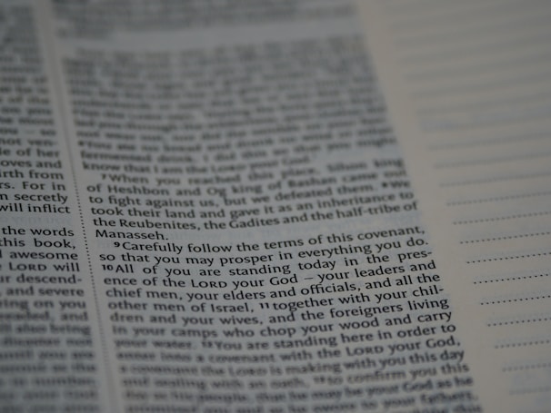 An open book with text printed on both visible pages. The left page contains paragraphs with varying sizes of text, and some words are in bold. The right page has sections of blank lines that appear to be for notes or annotations. The text is in English.