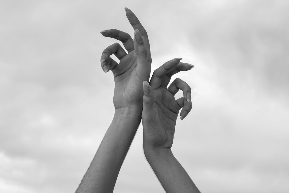 grayscale photo of 2 hands forming heart