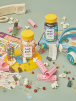 A collection of dopamine decor items including pink felt pennants with feminist slogans and kitschy kitchen goods.