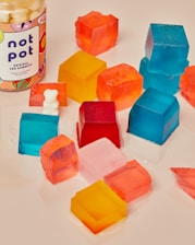 white and yellow plastic bottle beside blue plastic blocks