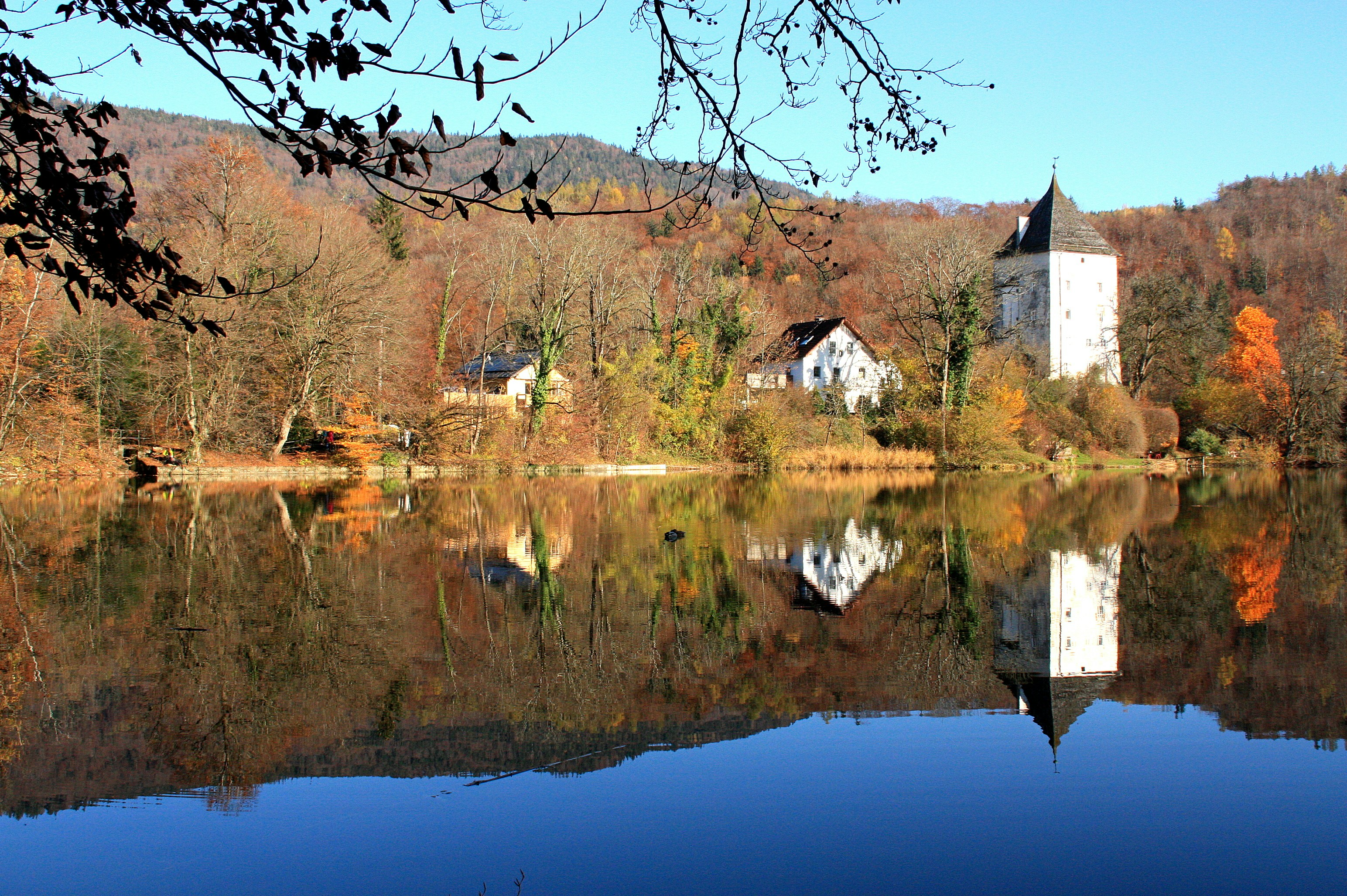 brown and white concrete house beside body of water during daytime, 