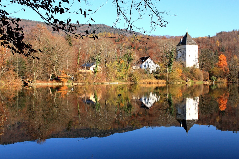 brown and white concrete house beside body of water during daytime